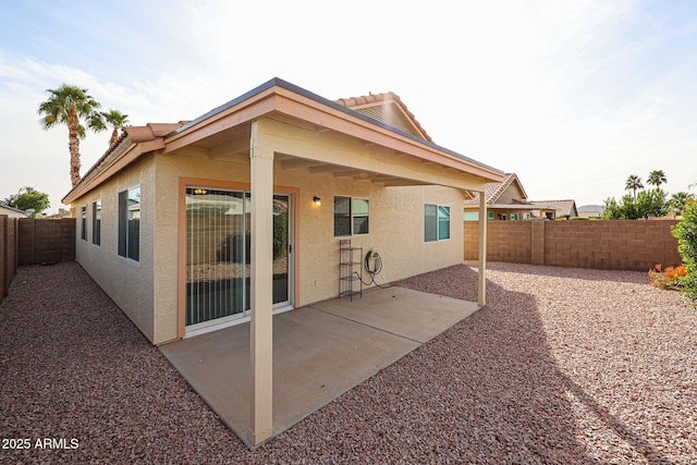 back of property with a patio area, a fenced backyard, and stucco siding