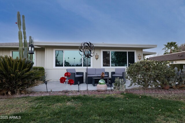 view of front of house featuring a patio area, a front lawn, and outdoor lounge area