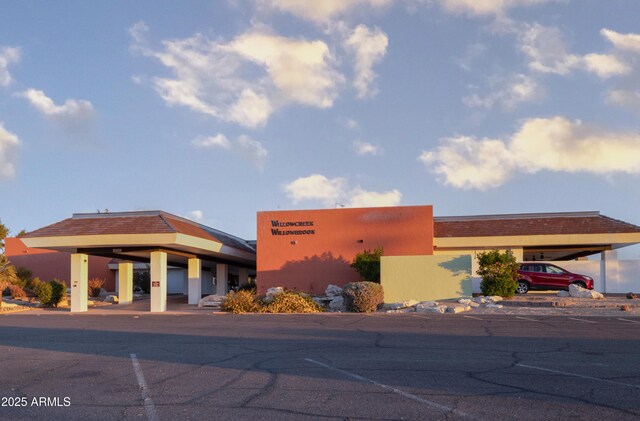 view of building exterior featuring uncovered parking