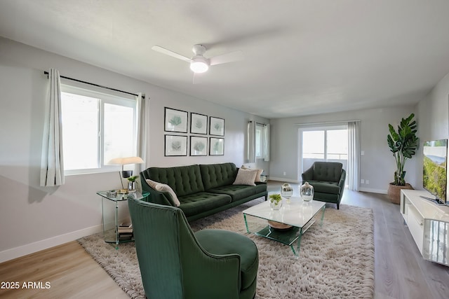 living room featuring ceiling fan and light wood-type flooring