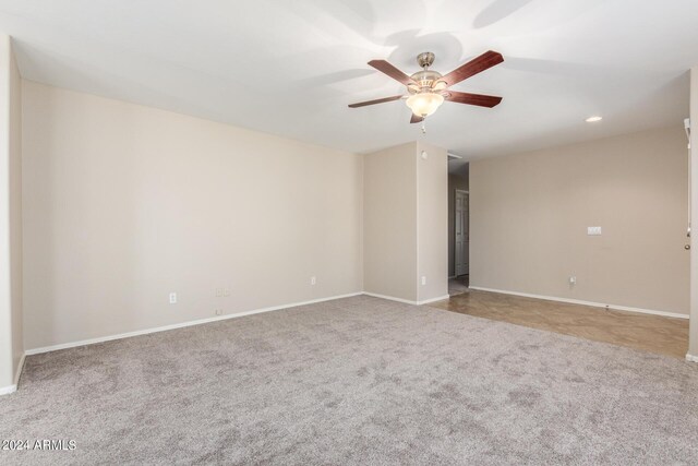 unfurnished room featuring light carpet and ceiling fan