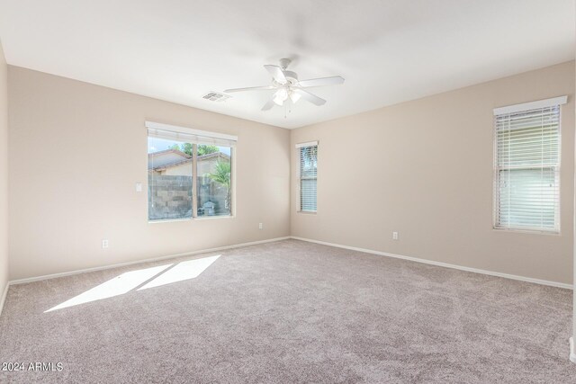 unfurnished room featuring ceiling fan and light colored carpet