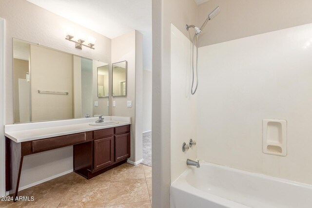 bathroom with tile patterned flooring, shower / bathtub combination, and vanity