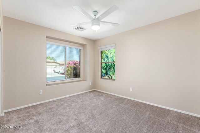 unfurnished room featuring ceiling fan and light colored carpet