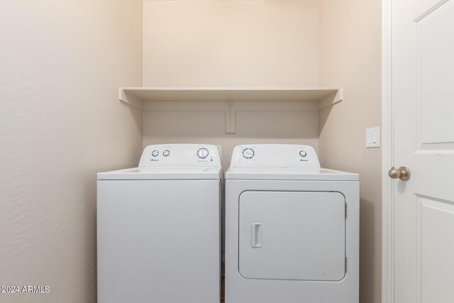 clothes washing area with washer and clothes dryer