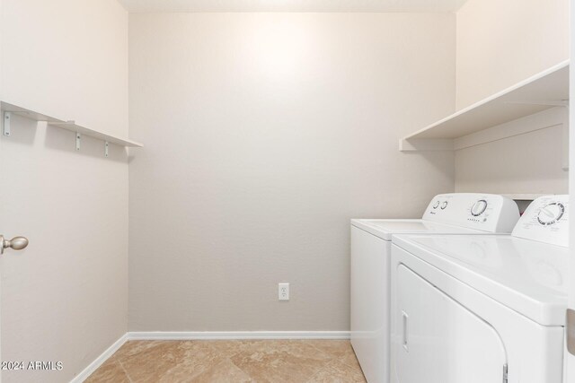 washroom with washing machine and dryer