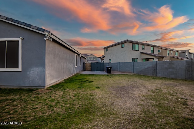 yard at dusk with a patio area