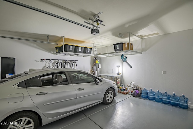 garage featuring a garage door opener and water heater