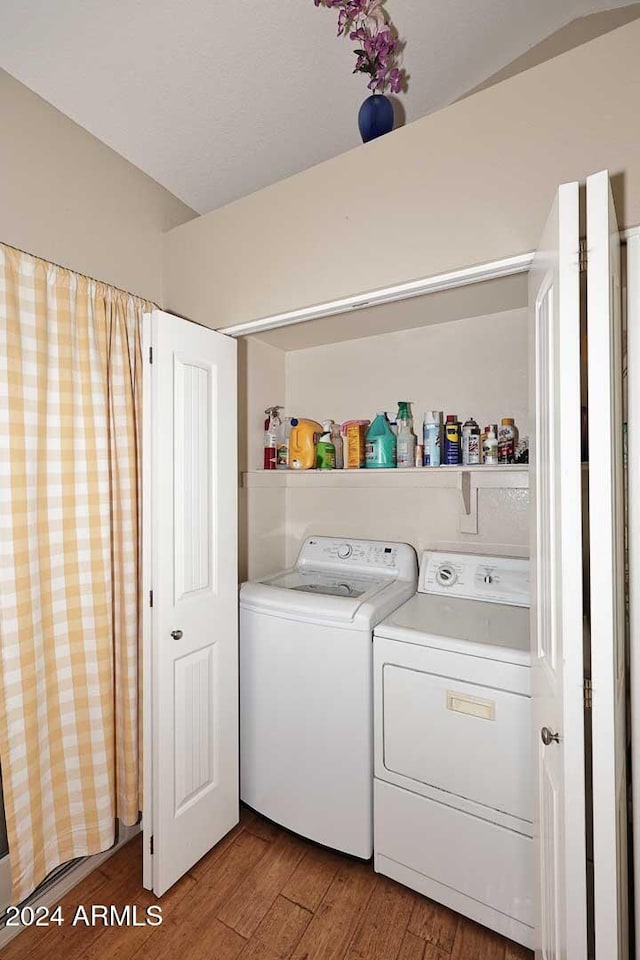 laundry room featuring washer and clothes dryer and wood-type flooring