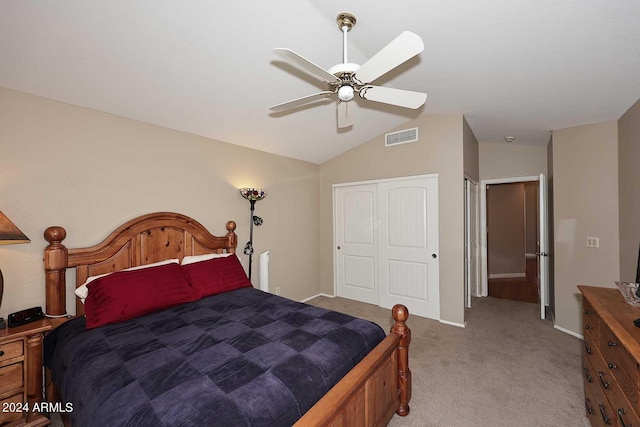 carpeted bedroom featuring a closet, ceiling fan, and lofted ceiling