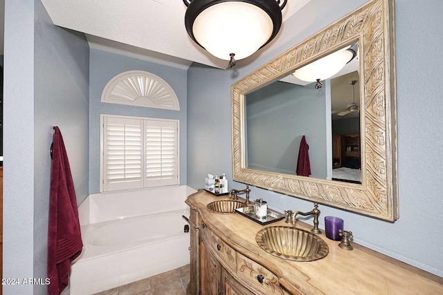 bathroom with vanity, a bathtub, and tile patterned floors