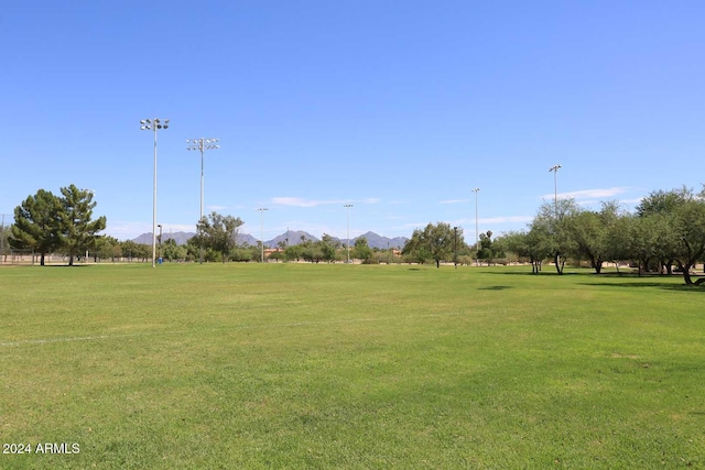 view of community with a yard and a mountain view