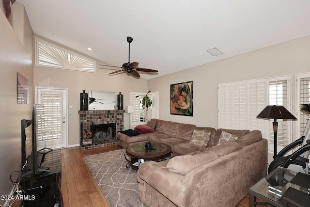 living room with ceiling fan and dark hardwood / wood-style flooring