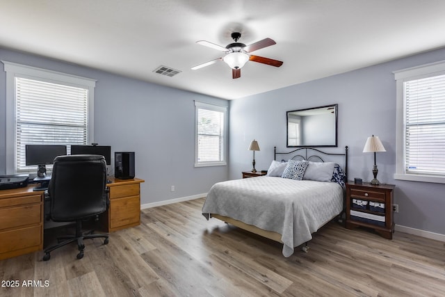 bedroom with ceiling fan and light hardwood / wood-style flooring