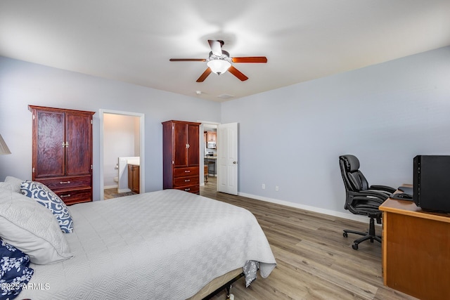 bedroom with ceiling fan, connected bathroom, and light wood-type flooring