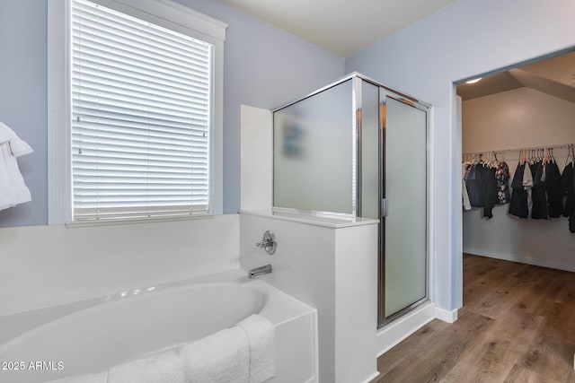 bathroom with hardwood / wood-style floors and plus walk in shower