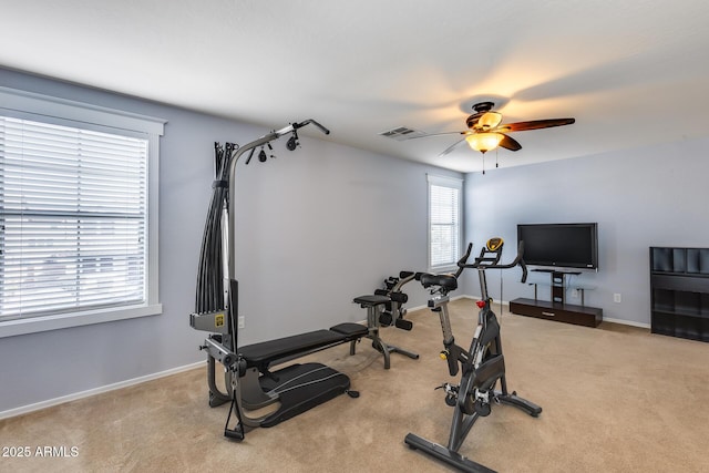 workout area featuring light colored carpet and ceiling fan