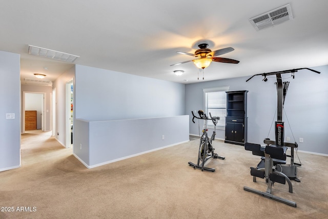 exercise area with light colored carpet and ceiling fan