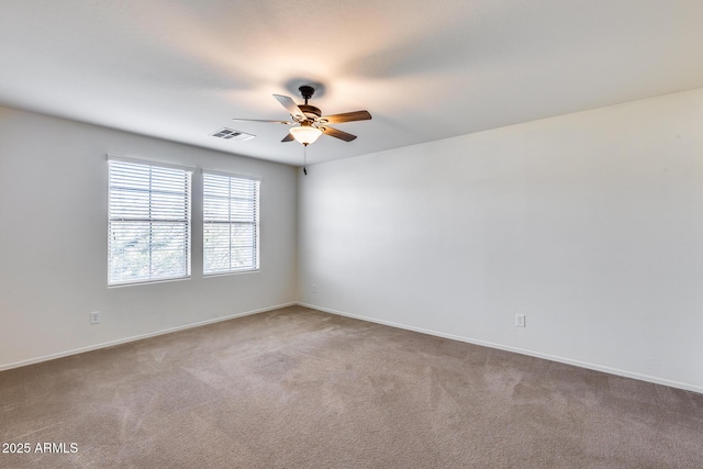 carpeted spare room featuring ceiling fan