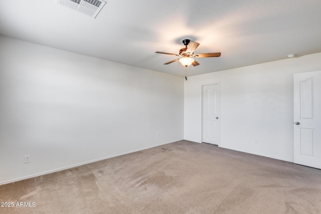 spare room with carpet floors and ceiling fan