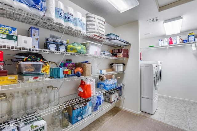 laundry room with tile patterned flooring and washing machine and clothes dryer