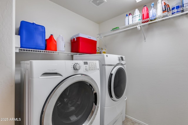 clothes washing area featuring washer and dryer