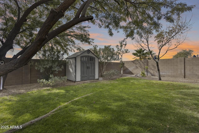 yard at dusk featuring a shed