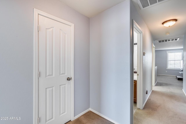 corridor with light colored carpet