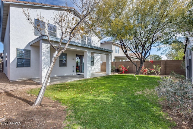 back of property featuring a patio and a lawn