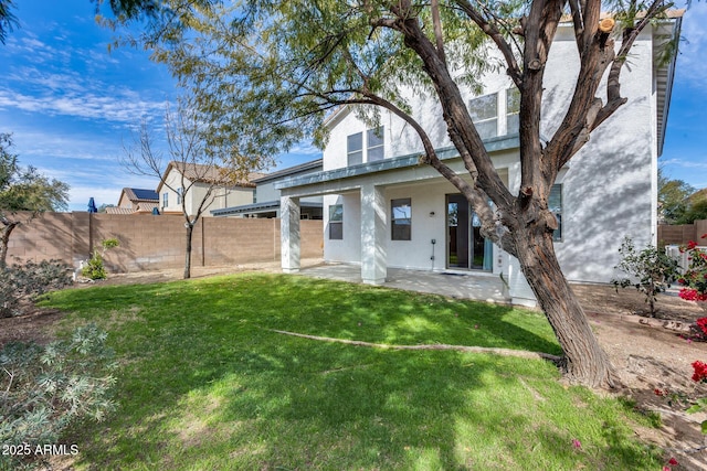 back of house with a yard and a patio area