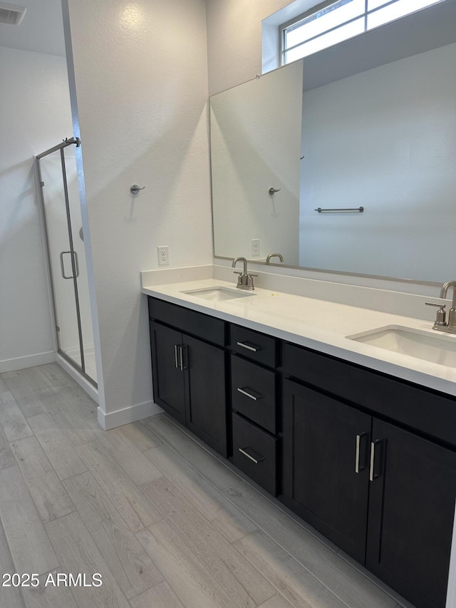 full bathroom with a shower stall, visible vents, and a sink