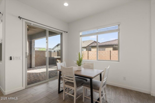 dining area featuring recessed lighting, baseboards, and wood finished floors