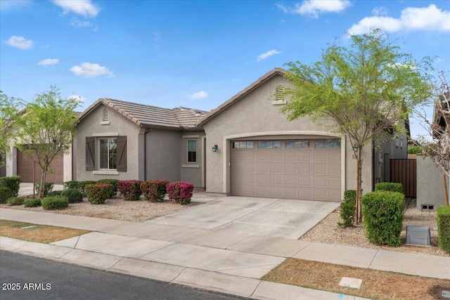 ranch-style home with stucco siding, fence, concrete driveway, a garage, and a tiled roof