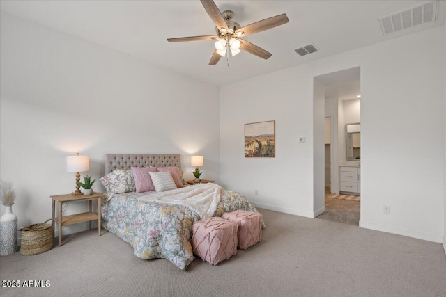 carpeted bedroom with visible vents, connected bathroom, a ceiling fan, and baseboards