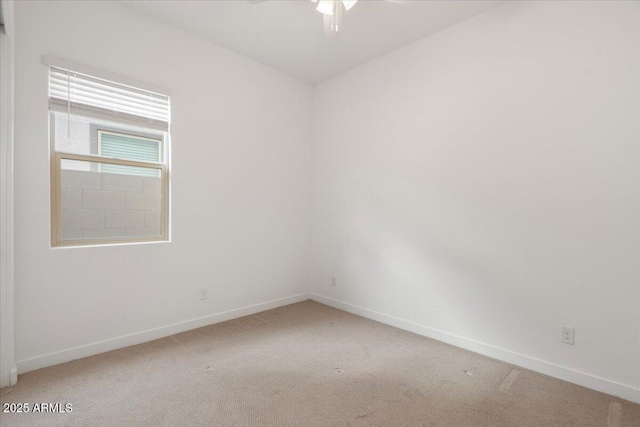 unfurnished room with carpet, baseboards, and ceiling fan