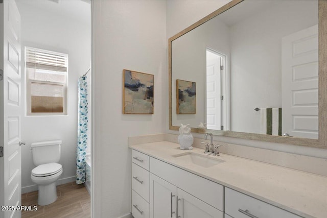 full bath with toilet, vanity, baseboards, and wood finished floors