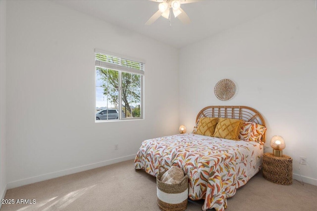 carpeted bedroom featuring ceiling fan and baseboards