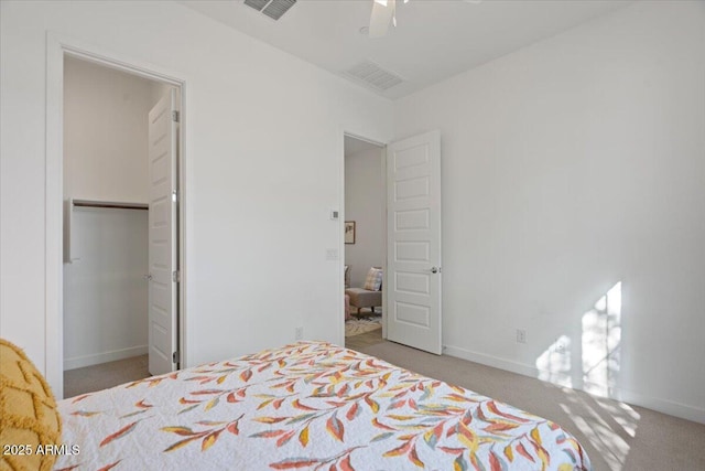 carpeted bedroom with a ceiling fan, baseboards, and visible vents