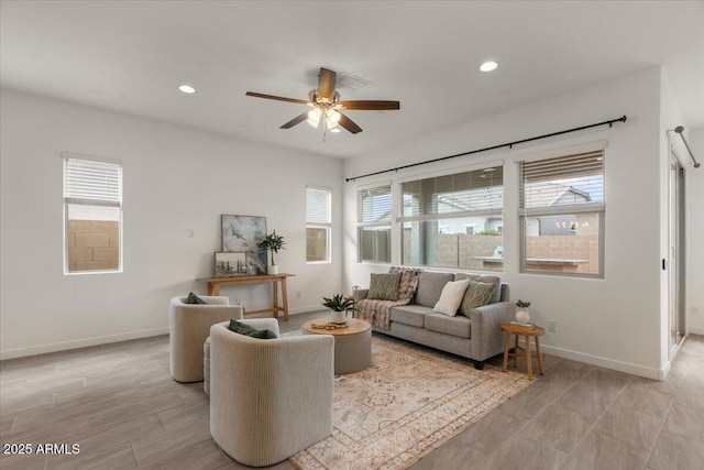 living area featuring recessed lighting, a healthy amount of sunlight, and baseboards