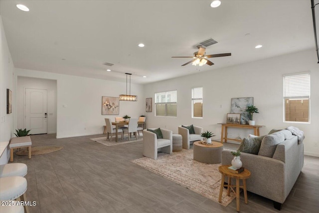 living area with recessed lighting, visible vents, baseboards, and a ceiling fan