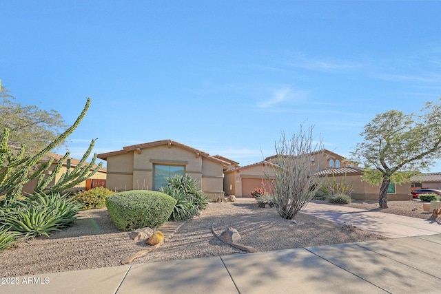 8687 W Bajada Rd, Peoria, AZ 85383 - view of front of property with a garage, concrete driveway, stucco siding, and a tiled roof
