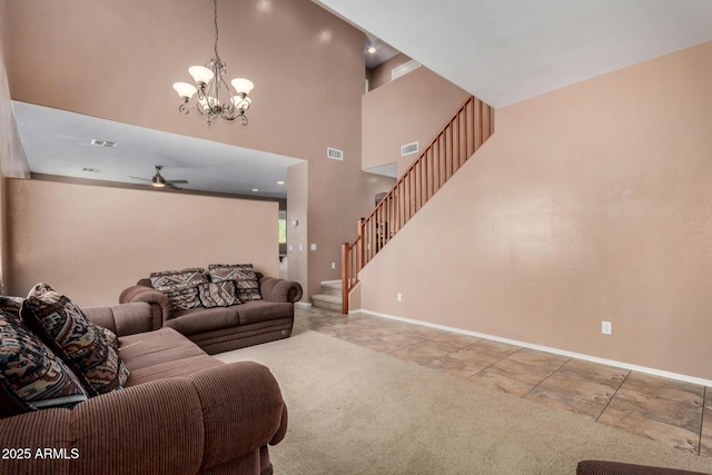 living room with visible vents, baseboards, ceiling fan with notable chandelier, and stairway