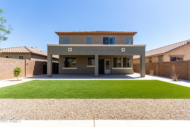 back of property featuring a fenced backyard, a patio, stucco siding, and a yard