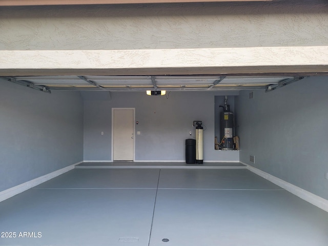 garage with water heater, baseboards, and a garage door opener