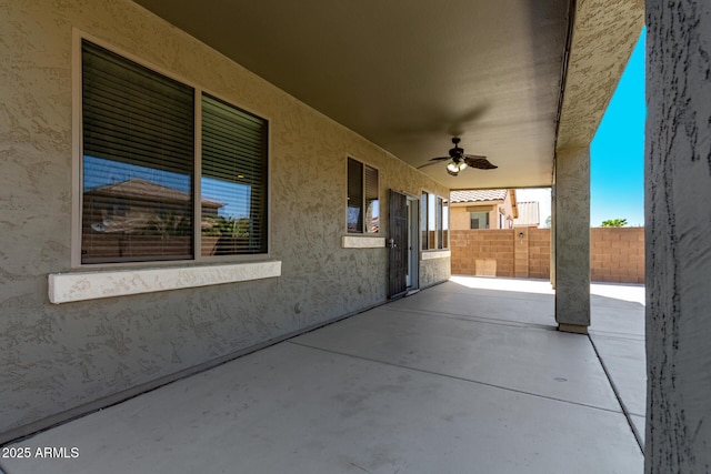 view of patio / terrace with fence and ceiling fan