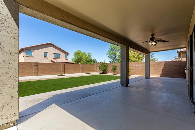view of patio with a fenced backyard and ceiling fan