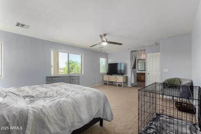 carpeted bedroom with visible vents, a ceiling fan, and baseboards
