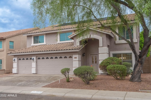 mediterranean / spanish-style home with a garage