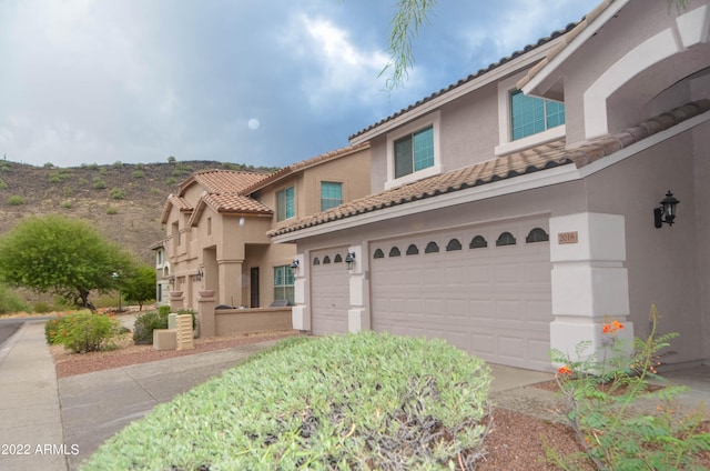 mediterranean / spanish-style house featuring a garage