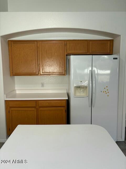 kitchen with white refrigerator with ice dispenser